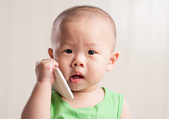 baby holding cellphone